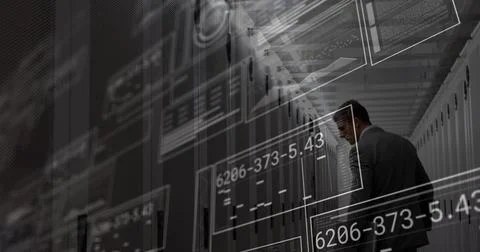 Inspecting engineer in dark suit checking server racks in server room with holo Stock Photos