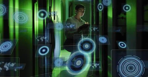 Inspecting female tech scanning server LEDs in datacenter holding tablet, in Stock Photos