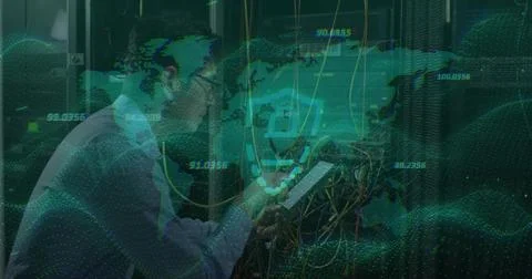 Inspecting Korean IT tech wearing light shirt tie checking tablet in data center Stock Photos