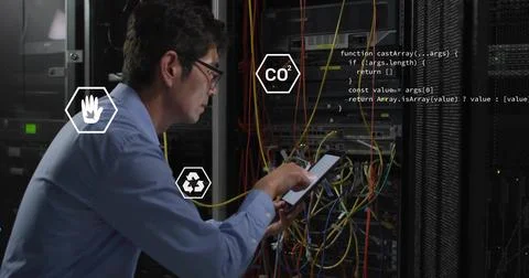 Inspecting Korean man tapping tablet at data center server rack, with cables, Stock Photos