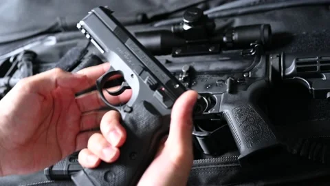Inspecting a loaded full sized pistol Stock Footage 146649864