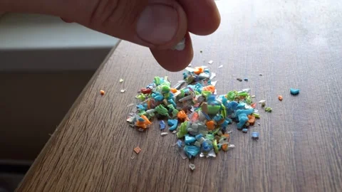 Inspecting a pile of microplastics collected from the sand on the beach. Stock Footage 283838140
