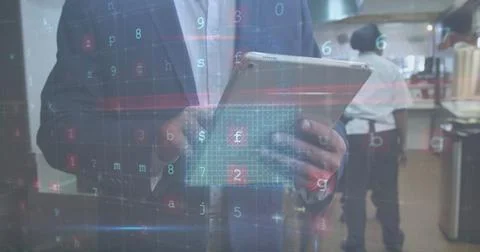 Inspecting suited manager holding tablet in commercial kitchen, with floating Stock Photos