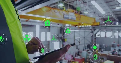 Inspecting tech in neon vest using tablet, viewing AR icons in plant, yellow 写真素材