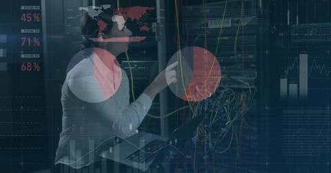 Inspecting tech in sweater in datacenter aisle, checking server rack with cables Stock Photos