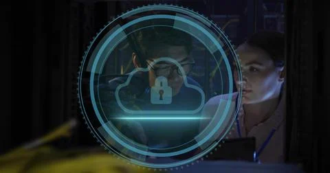 Inspecting techs in light blouse, dark top, checking laptop with cloud-lock Stock Photos