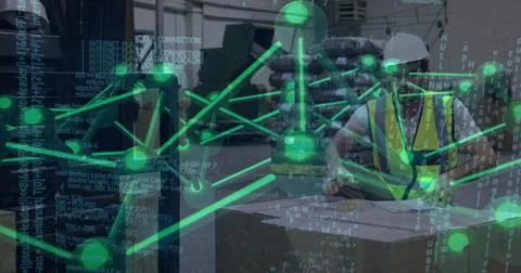 Inspecting worker wearing hard hat in warehouse bay with crate and digital 스톡 사진