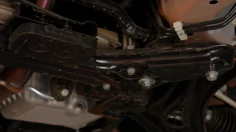 Inspection of the bottom of a car standing on a jack stand. Видео 248166589