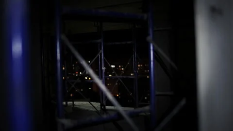 Inspection of construction scaffolding using flashlight in dark interior Stock Footage 323434296