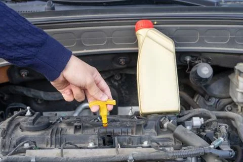Inspection of the engine oil or checking motor oil level Stock Photos