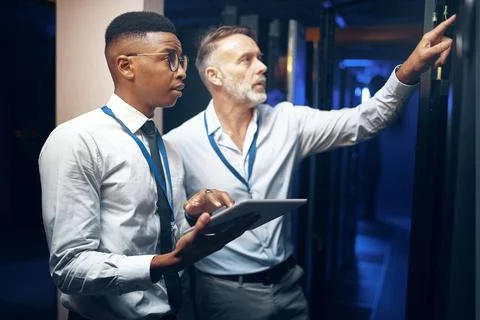 Inspection, engineer or men with tablet in server room, system backup process or Stock Photos