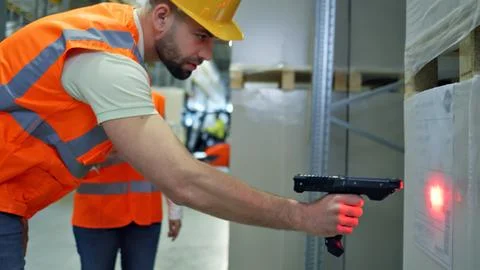 Inspection with a laser pointer in a warehouse. Stock Photos