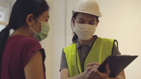 Inspector checking list on work and talk with owner Stock Footage 133906168