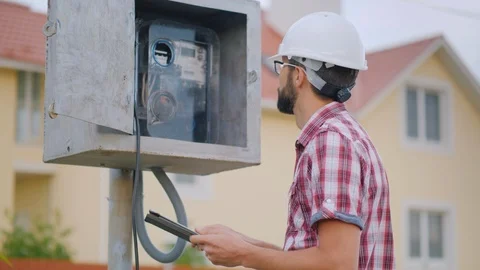 The inspector checks the meter reading. Records the testimony in the tablet Stock Footage 90661600
