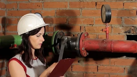 The inspector checks the readings of the manometer. The engineer approves the Stock Footage 76260336