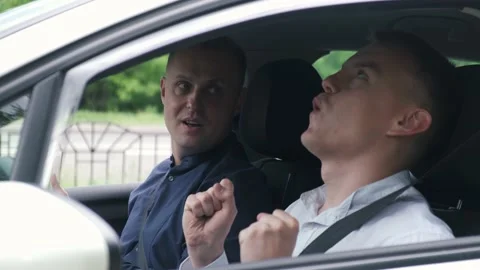 Inspector congratulates a man on passing a driving test Stock Footage 131523041