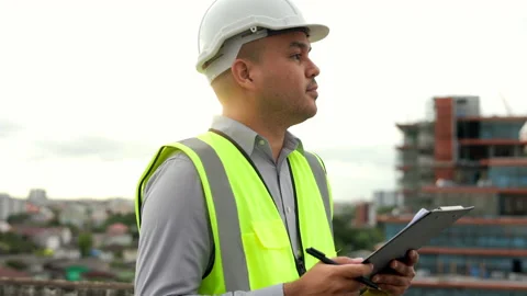 Inspector engineer handsome man or architect looking clipboard with white safety Stock Footage 164838403