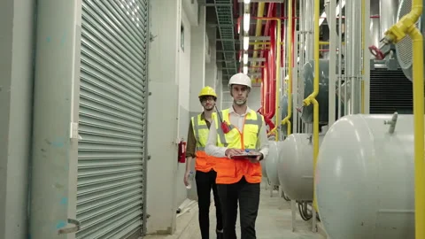 Inspector, Engineer Or the foreman patrolling the boiler room in the factory Stock Footage 154187275