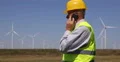 Inspector Engineer Report Man Talking Phone Wind Turbines Power Plant Farm Field 4k or 4k+ Resolution