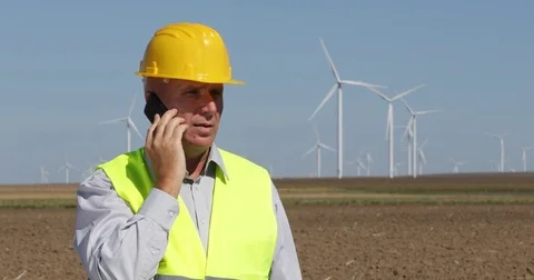 Inspector Engineer Report Man Talking Phone Wind Turbines Power Plant Farm Field Stock Footage 83664829