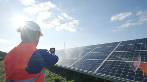 Inspector examination of photovoltaic modules using a thermal imaging camera Stock Footage 157008329