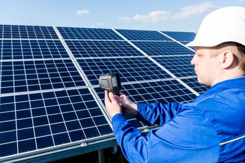 Inspector examination of photovoltaic modules using a thermal imaging camera Stock Photos