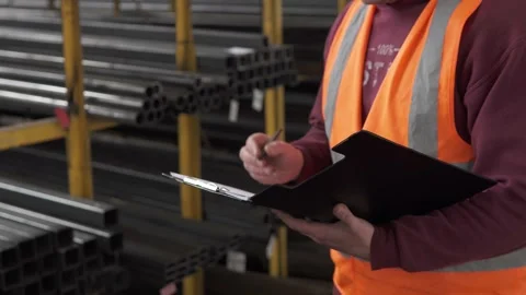 The inspector of inventory control of rolled metal makes entries in the journal. Stock Footage 276549478