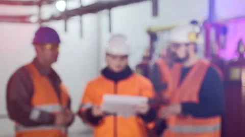 Inspector with papers talks to colleagues checking complex Stock Footage 143669754