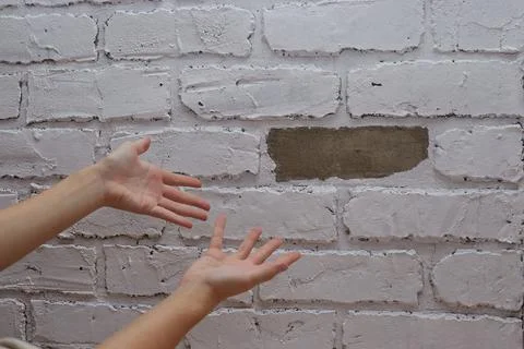 The inspector points his finger at the broken wall poor repair Stock Photos