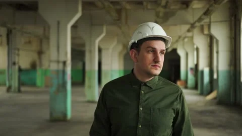 The inspector puts on a white helmet. Goes over the line object, looks around Stock Footage 152680035