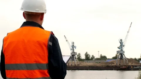 The inspector records the problems identified in the operation of port cranes in Stock Footage 95313761