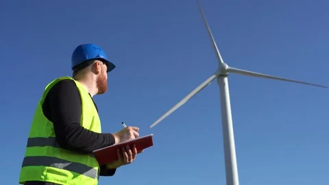 Inspector signing documents near windmill Stock Footage 143254623