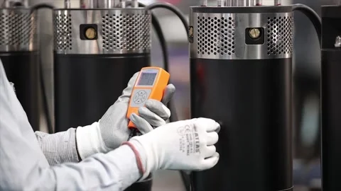 Inspector using an digital testing device to performance a black industrial Stock Footage 327774305