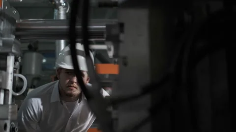 The inspector in a white helmet checks the state of the gas installation in the Stock Footage 107413872