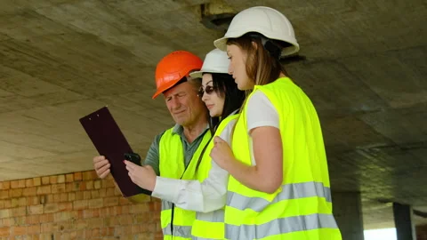 Inspectors and builder study technical details of project Video stock 317611400