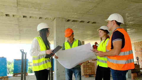 Inspectors and workers discuss technical documentation Stock Footage 317612773