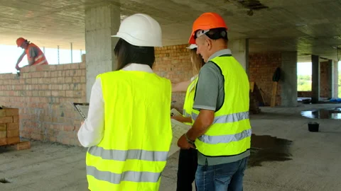 Inspectors perform layout analysis looking at building areas Stock Footage 317610479