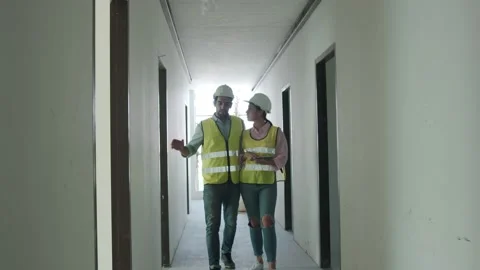 Inspectors walk inside building construction checking progress success room Stock Footage 146888234
