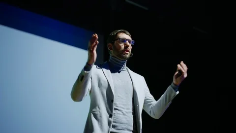 Inspirational Male Speaker Does Presentation of New Technological Product Stock Footage 122811077