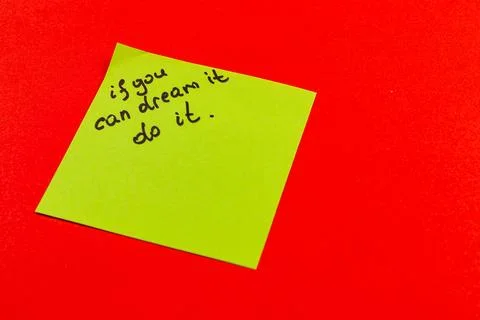 Inspirational note on bright colored background encourages action and dreams Stock Photos