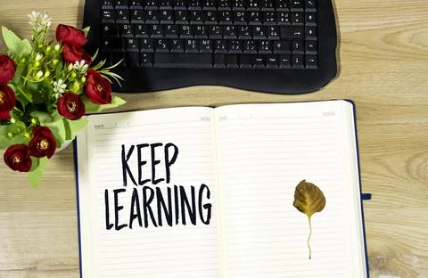 Inspirational Open Notebook with Message and Keyboard on Wooden Desk Stock Photos