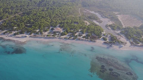 Inspire 2 drone flying across empty beach with blue water Stock Footage 101427878