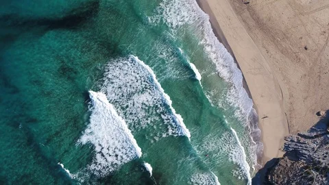 Inspire 2 Drone flying over big waves on turquoise water with surfers Stock Footage 101428244