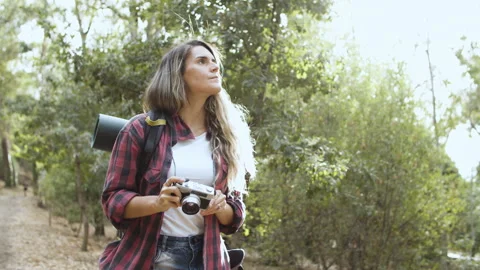 Inspired backpacker girl with camera taking pictures of forest Stock Footage 150213429