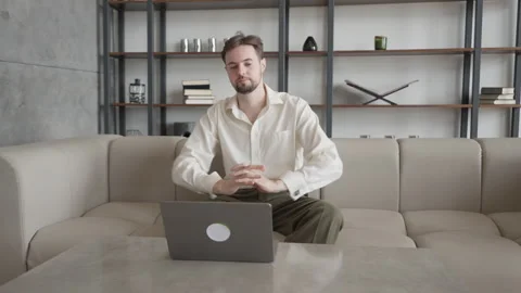 Inspired Businessman Sitting Down To Work On Laptop In Modern Office Space Stock Footage 301247489