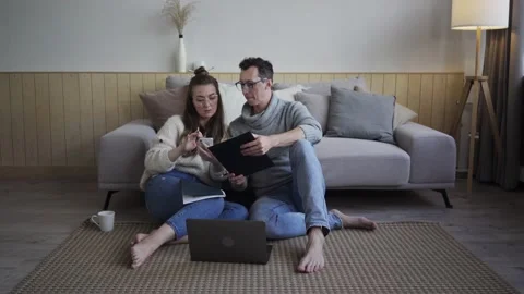 Inspired couple discussing project plans. Young freelancers with gadget and Stock Footage 139573482