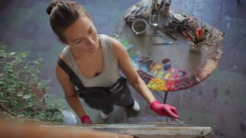 Inspired female painter creating artwork Video stock 142669710
