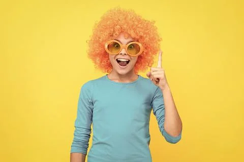 Inspired with idea. girl birthday party. happy funny kid in curly wig. time to Stock Photos