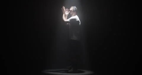 Inspired millennial man dancing in spotlight Stock Footage 244525416