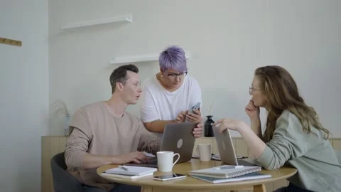 Inspired modern workers with gadgets at table. Inspired couple with manager Stock Footage 139593445
